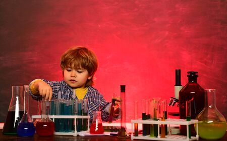 What is taught in chemistry. Child from elementary school. Happy little scientist making experiment with test tube. Preschooler.の写真素材