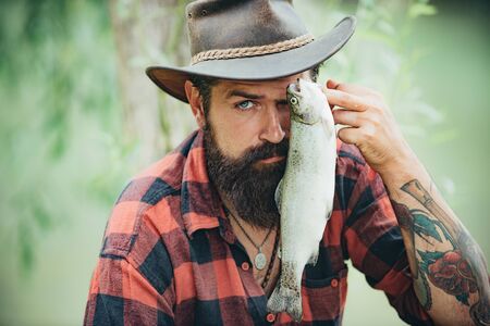 Fishes catching hooks. Fishing became a popular recreational activity. Bass fishing. Fish on the hook. Concepts of successful fishing.の写真素材