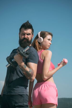 fitness music. barbell equipment. dumbbell lifting. sport and fitness. bearded man and woman with fit belly. healthy lifestyle. dieting. freedom. sporty couple training outdoor. perfect body muscle.の写真素材