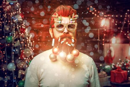 Magic Christmas bokeh - crazy man. Christmas beard decorations. Merry Christmas and happy new year greeting card. Christmas Celebration holiday.の写真素材