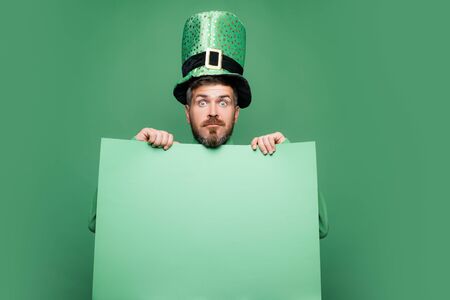 Shocked and happy male face. Happy Saint Patricks day. Hipster in leprechaun hat and costume with...