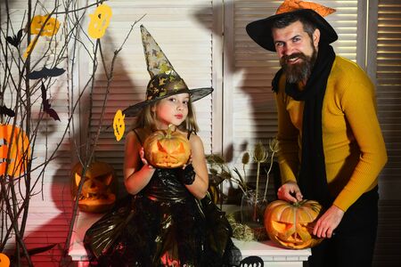 Halloween party concept. Wizard and little witch in hatsの写真素材