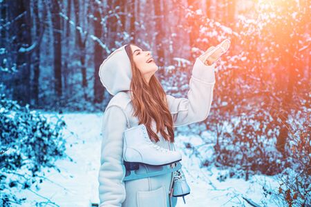 Winter girl having fun in winter park. Global cooling. Winter portrait of young woman in the winter snowy scenery.の写真素材