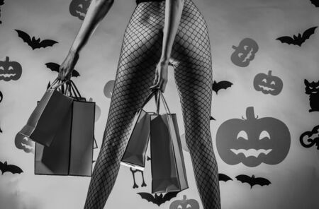 Halloween background. Halloween decoration and scary concept. Magic pumpkin. Happy smiling woman on Halloween background.の写真素材