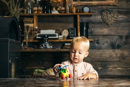 Adorable toddler play with toy helicopter in kindergarten. Kindergarten and nurseryの写真素材