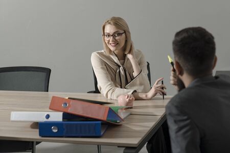 Happy businesswoman and manager at work process. Woman boss with financier in office. Sensual woman...