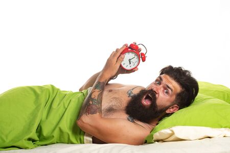 Alarm concept. Young man sleeping on bed. Good morning. Sleeping time.の写真素材