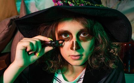 Close up Witch Portrait. Halloween child. Home Halloween atmosphere.