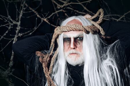 Devil in wicked witch hat. Halloween Devil with bloody professional makeup. Halloween. Devil man on Halloween night. Halloween man with Blood make up.の写真素材