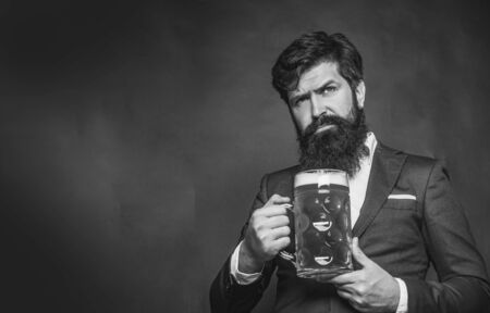 Banner - Beer pubs and bars. Enjoy in pub. Retro man in black suit with a beer. Retro advertising of alcoholic beverages.の写真素材