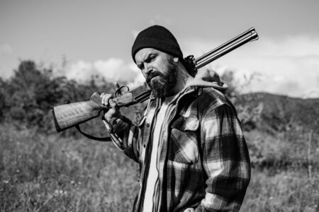 Hunter with shotgun gun on hunt. Gun rifle. Hunter man. A hunter with a hunting gun and hunting form to hunt in forest.の写真素材