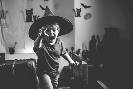 Halloween kid. Magik child halloween. Horror faces. Expression face - surprised cute boy.の写真素材