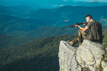 Hunter with a shotgun in a traditional shooting clothing. Wildlife Hunting. Hunting Gear - Hunting Supplies and Equipment. Closed and open hunting season.の写真素材