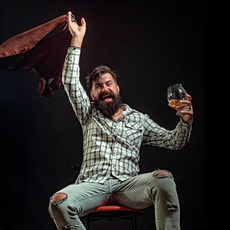 Alcohol abuse: drunk man looking at a glass of whiskey. Actual social problem. Treatment for alcohol...