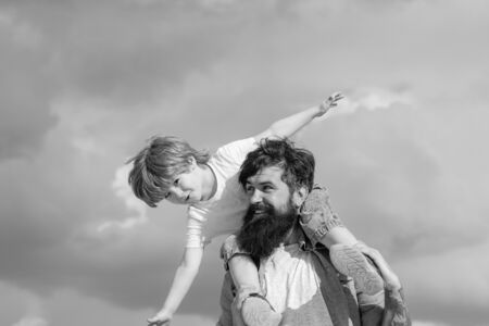 Happy loving family - Father and son. Dream of flying. Happy family father and child on meadow with a kite in the summer on the nature.の写真素材