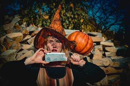 Holiday Halloween carnival costume. Halloween party art design. Beautiful young surprised woman in...