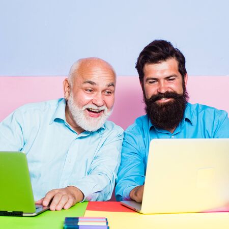 Smiling broker consulting customer showing computer presentation. Two colleagues working together at...