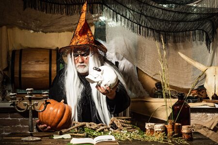Bearded man dressed like Halloween monster. Portrait of Devil with Halloween bloody make up showing...