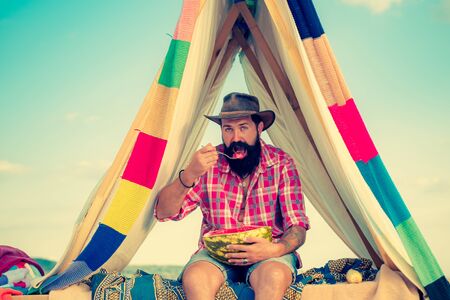 You cant buy love. Shelter of branches. Camping in improvised wooden house in nature. Adventure travel. Hiking and outdoor recreation concept with flat camping travel.の写真素材