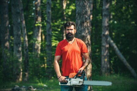 Lumberjack with chainsaw in his hands. Chainsaw. Deforestation is a major cause of land degradation and destabilization of natural ecosystems.の写真素材
