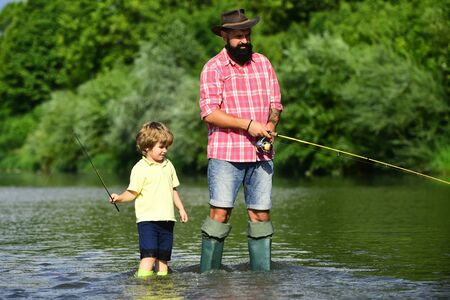 Father and son fishing and relaxing while enjoying hobby. Anglers. Fishermen father and son fishing...