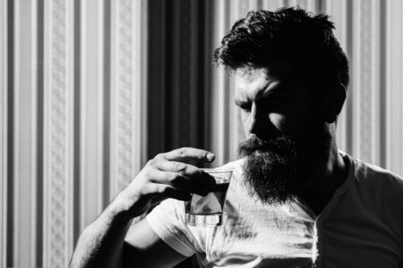 Man relaxing and enjoing. Portrait of self confident brutal man whiskey drinker. Whisky, brandy or cognac concept.の写真素材