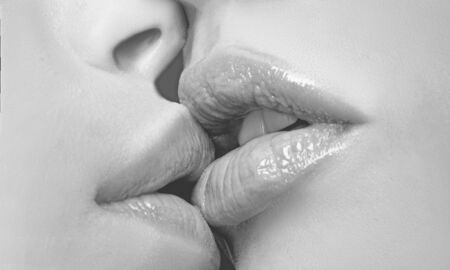 Two lesbian friends kissing. Sensual lips kisses. Passion and sensual touch.の写真素材