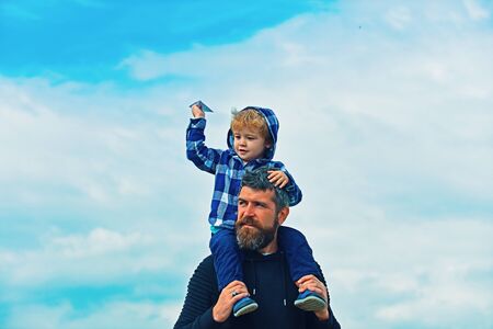 Father and son playing together. Father and his son child boy playing outdoors. Childhood. Freedom to Dream - Joyful Boy Playing With Paper Airplane.の写真素材