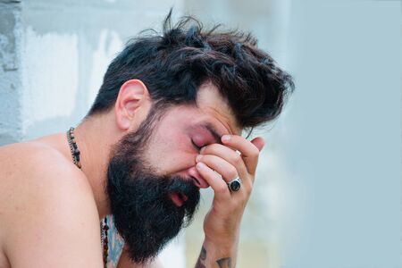 Hangover attacked unexpectedly. Morning after few drinks can be harsh sometimes. Overworked. Bearded man. Male barber fashion care. Tired man feeling overworked.の写真素材