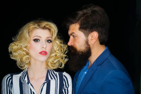Close up photo of beautiful couple on isolated background. Attractive woman with bearded hipster...