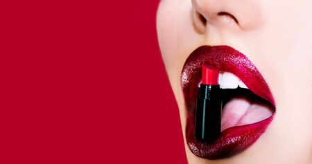 Sexy plump full lips. Lip care and protection. Lips isolated on red background. Lips and beauty make upの写真素材