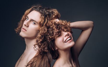 Family couple man and sexy girl. Studio shot of couple fooling around in valentines day. Young beautiful couple in love. Glad girl having fun with boyfriend. Smile joyfully have good relationships.の写真素材