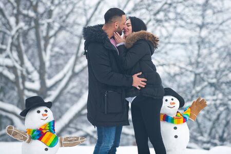 Winter adventure. Passionate man gently kissing beautiful woman with desire. Kissing winter couple...