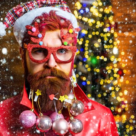 Bearded modern Santa Claus close up portrait. Merry christmas and happy new year. New year - fun party with funny Santaの写真素材