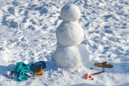 Making snowman and winter fun. New year Christmas concept. Making Snowman outdoor - copy spaceの写真素材