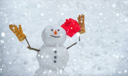 Merry Christmas and happy new year greeting card. Festive Art Greeting Card. New Year banner. Snowmen - gift presents concept. Snowman gifting. Happy smiling snow man - sale discount conceptの写真素材