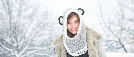 Happy girl winter portrait. Winter woman. Portrait of a young woman in snow. Beauty Winter Girl in frosty winter Park.の写真素材