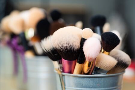 Facial brush set for makeup artist or visagist. Natural soft brushes standing in a pot. Close up macro photo of professional makeup brushesの写真素材