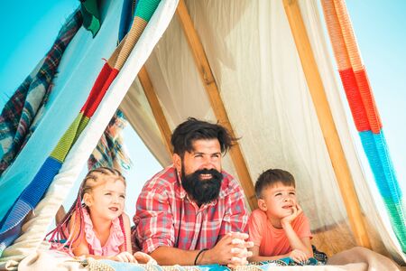 Fathers day. Little cute children feel happy and laugh. Playhouse for kids located at roof and...