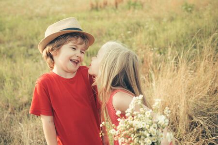 Valentines day concept. First love. The concept of child friendship and kindness. Kid having fun in spring field. Valentines day card.の写真素材