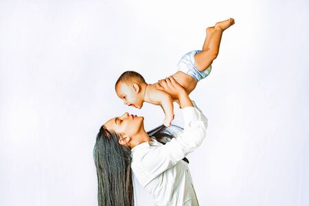 Happy Mother and baby. Young mother playing whith her newborn baby. Happy. Family maternity...