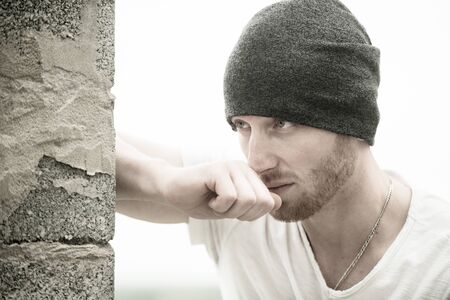 Handsome young man on grey background looking at camera. Portrait of a handsome man against grey background with copy space.の写真素材