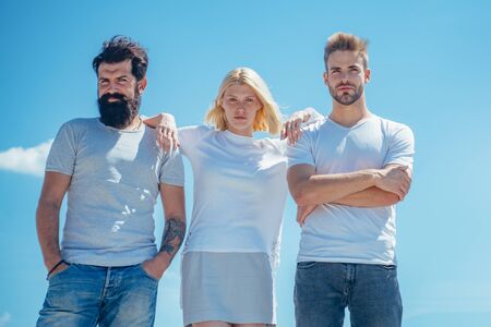 Group of friends at clear sky background. Happy friends vacation. Young team on blue background...