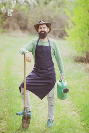 Farmar enjoy spring nature and take care about her plants. Gardener. Country life. Farming and agriculture cultivation.の写真素材