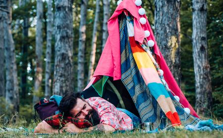 Camping outdoor back to nature. You cant buy love. Go Ape Adventure. Happy man in summer. Traveling and Camping with a Tent. Camping lifestyle.の写真素材