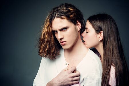 A beautiful young couple hugging and holding each other in the studio. Close up portrait. Young couple in love. Relationship. Affectionate couple. Loving everything about her.の写真素材