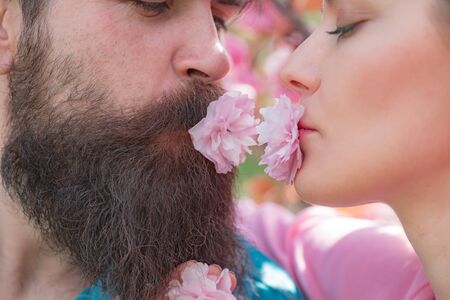 Kissing couple in spring nature close-up portrait. Passionate affectionate man and woman enjoying exciting moment of first kiss. Feeling desire.の写真素材