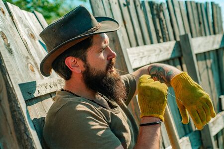 Farmer in the farm on countryside background. Farmer harvesting fresh vegetables from the garden and planning harvest.の写真素材