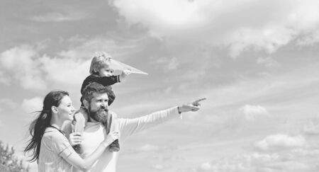 Happy family - mother, father and son on sky background in summer. Dream of flying. Happy family...