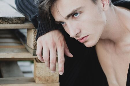 Handsome bearded man posing on wooden background. Confident and handsome man. Portrait of handsome man against grey wall.の写真素材